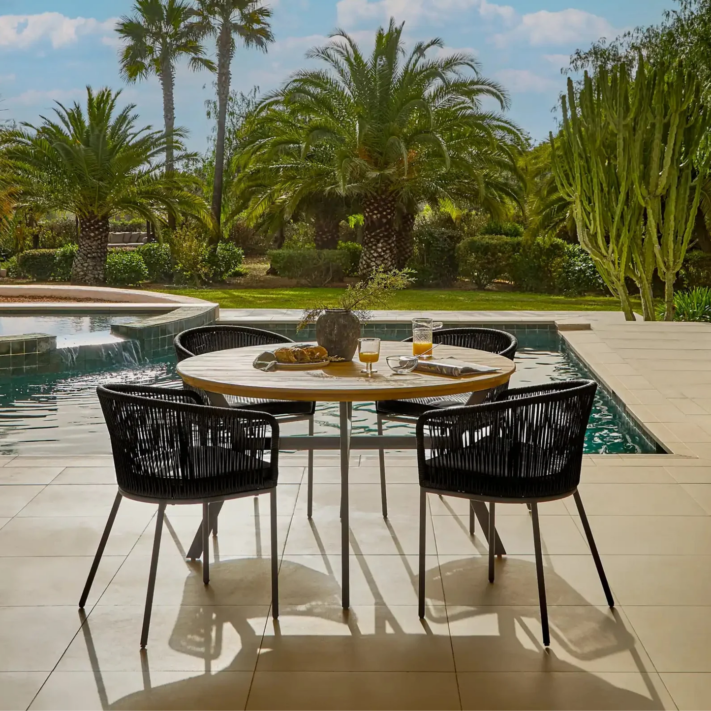 Ezra Whitewash Round Outdoor Dining Table Set with Black Hali Rope Chairs - Laura James